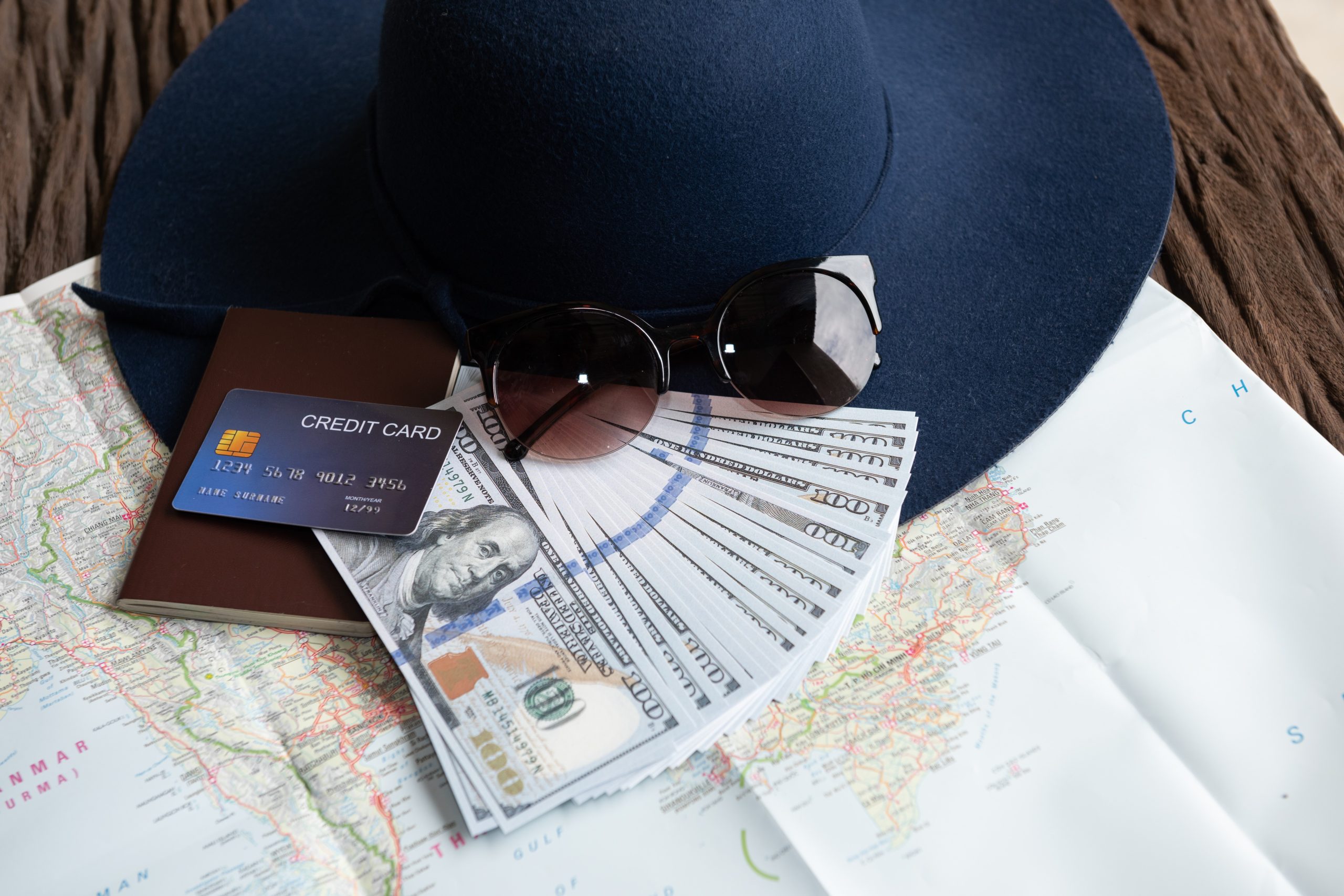 dollar-banknotes-sunglasses-credit-card-passport-blue-hat-1